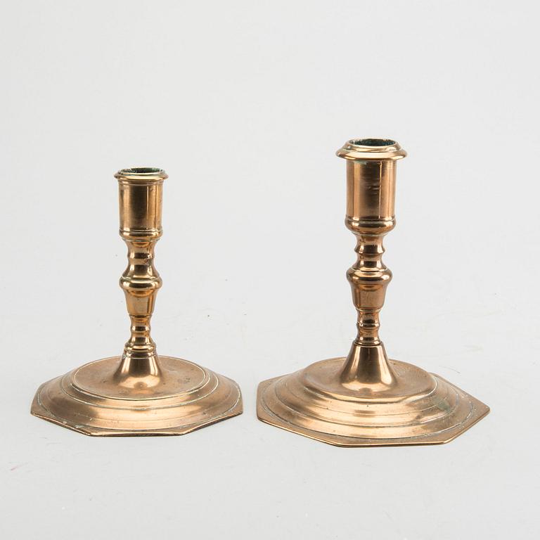 A set of four late Baroque brass candlesticks.