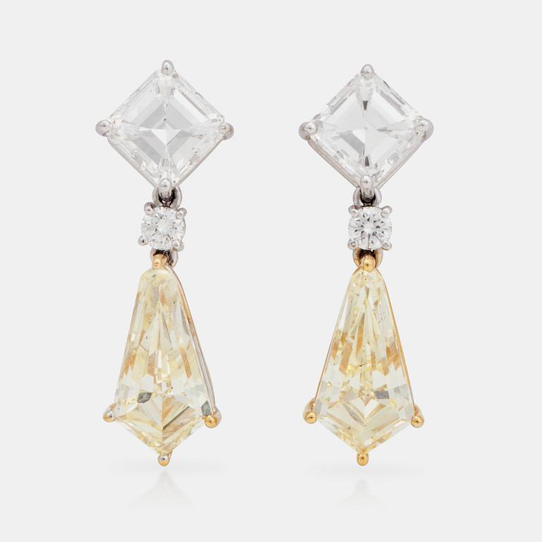 A pair of Fancy Light Yellow and colourless diamond earrings. Total carat weight 8.07cts.