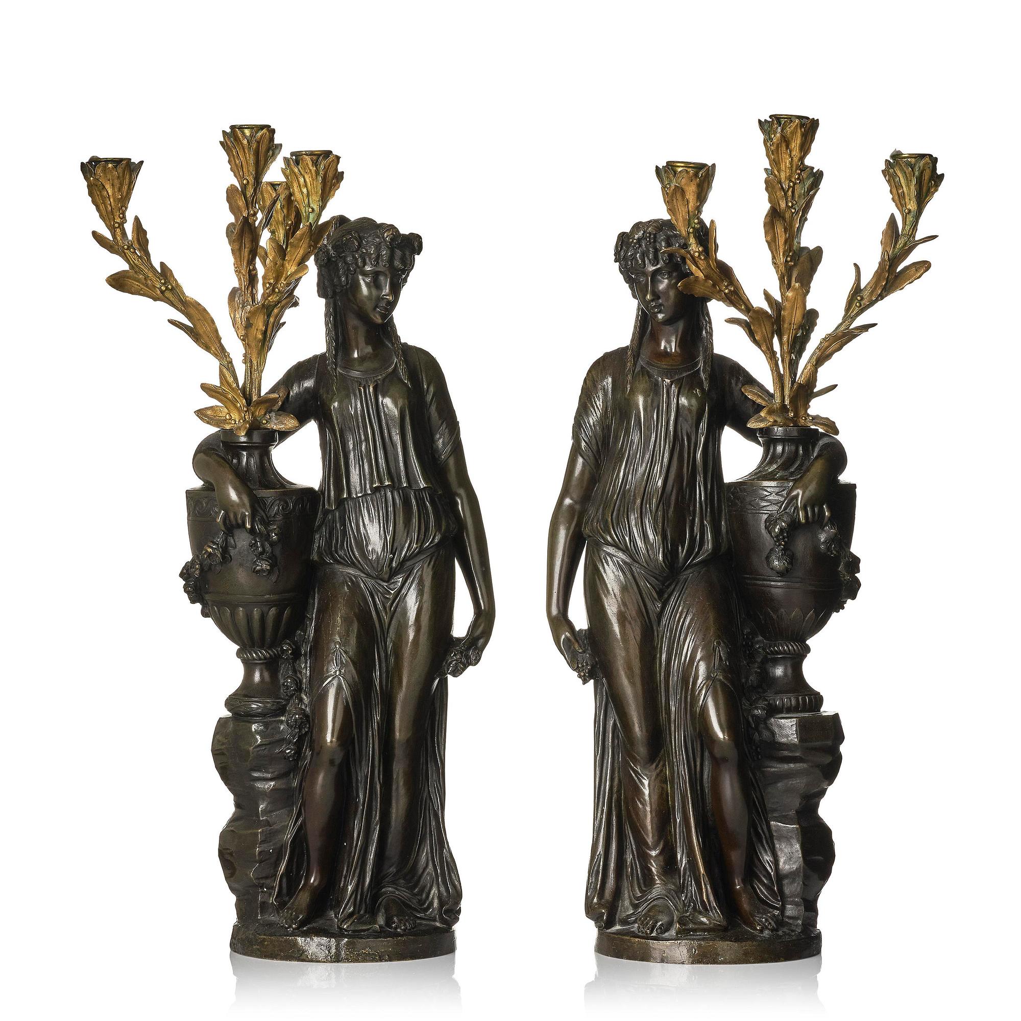 A pair of Louis XVI-style four-light gilt and patinated bronze candelabra after Clodion, later part 18th century.