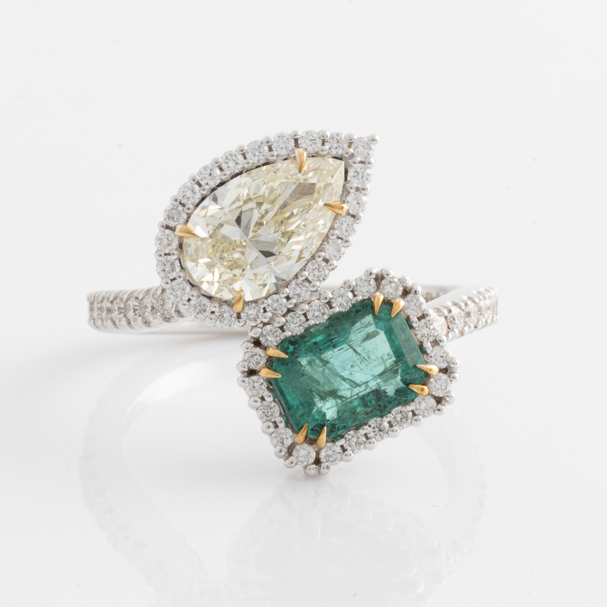 Ring with emerald-cut emerald and pear-shaped diamond, accompanying GIA diamond report.