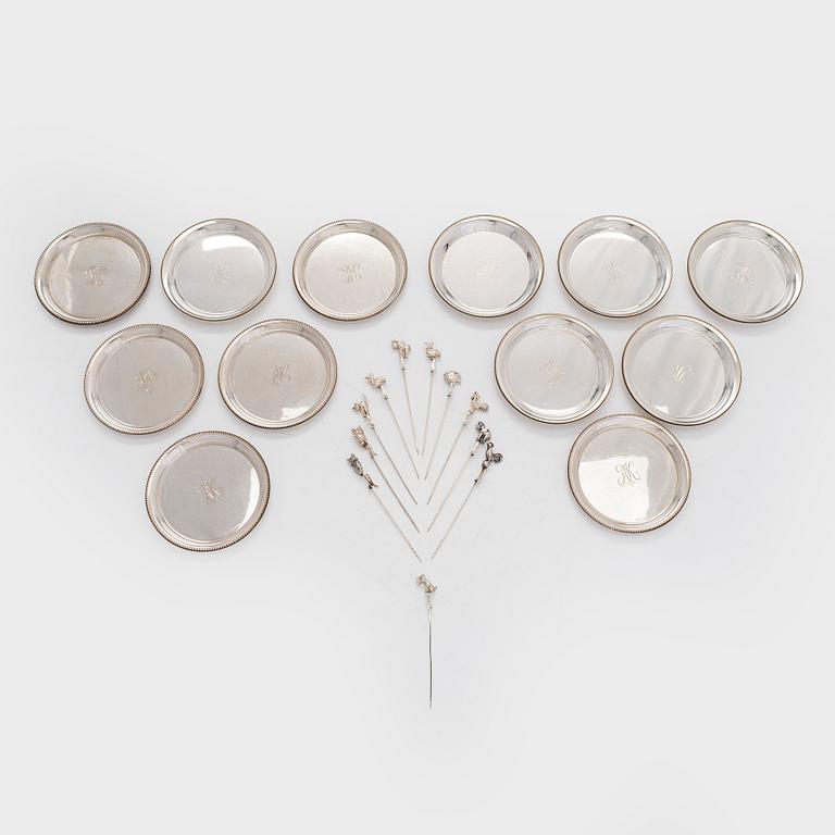 A set of twelve silver coasters and cocktail sticks 11 pcs,  Suomen Kultaseppä Oy 1935 and Kultakeskus 1983.