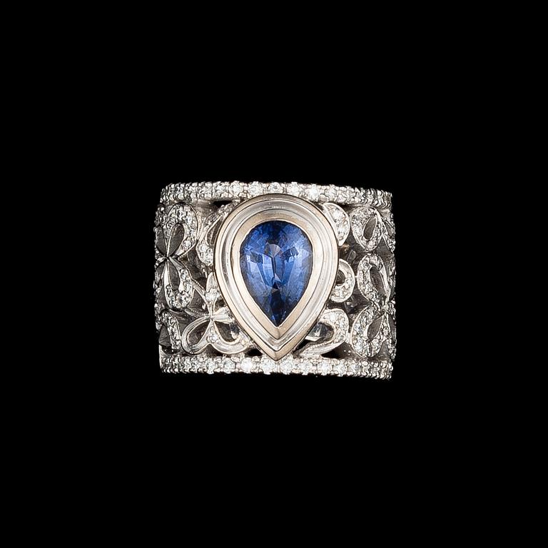 A RING, drop cut sapphire, brilliant cut diamonds, 18K white gold. .