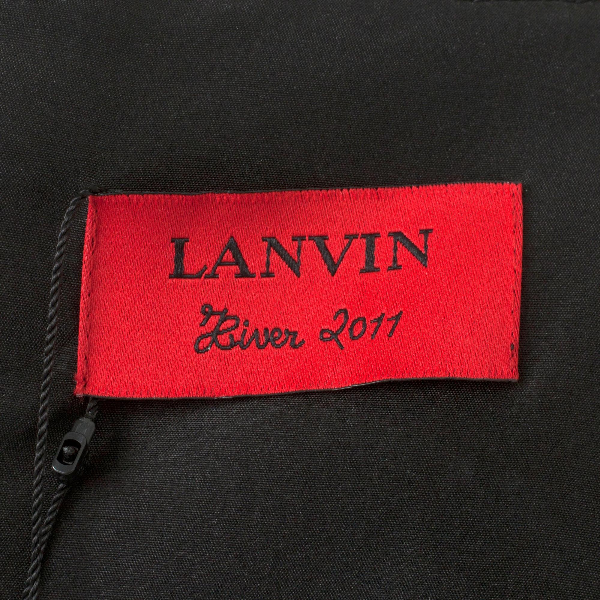LANVIN, a black wool blend dress with ruffles.