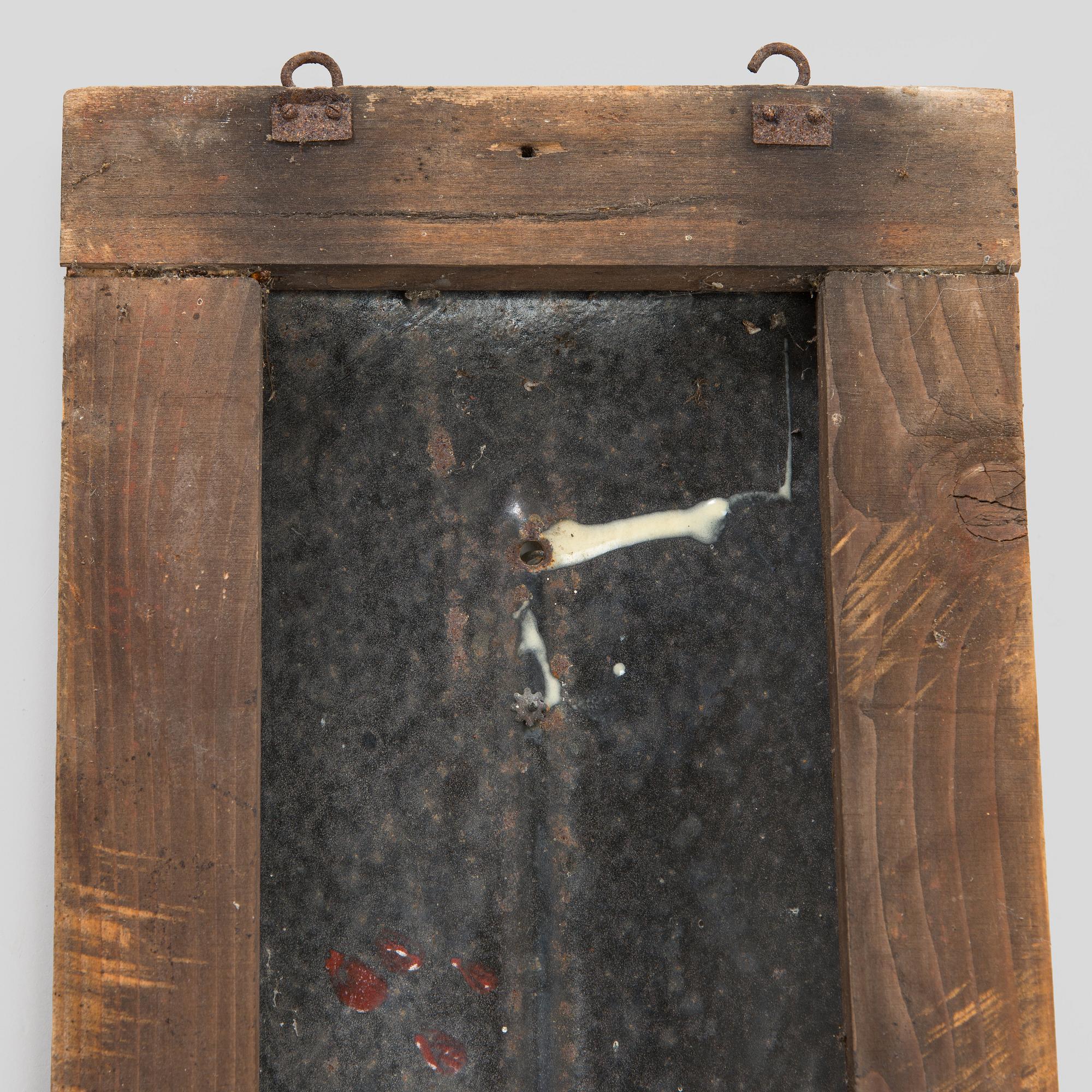 a mid-20th century outdoor thermometer.