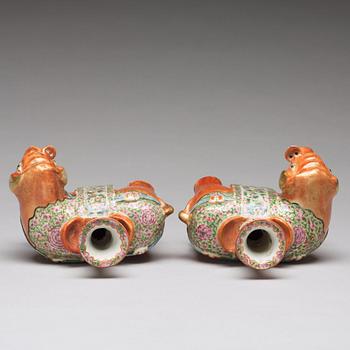 A pair of famille rose Canton elephant candle holders, late Qing dynasty, about 1900.