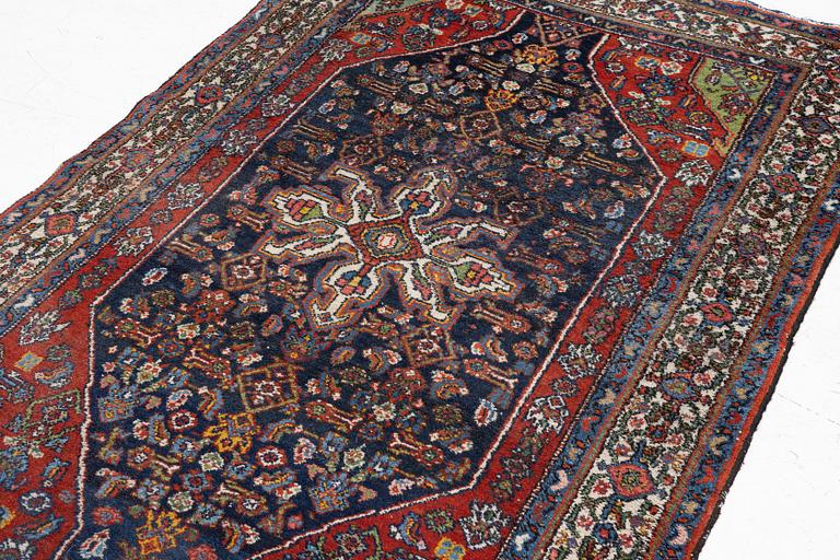 An oriental, semi-antique rug, c. 195 x 130 cm.