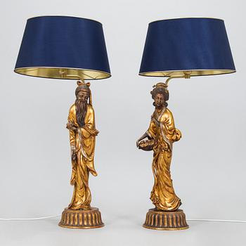 A pair of table lamps with Asian figures, later half of 20th century.