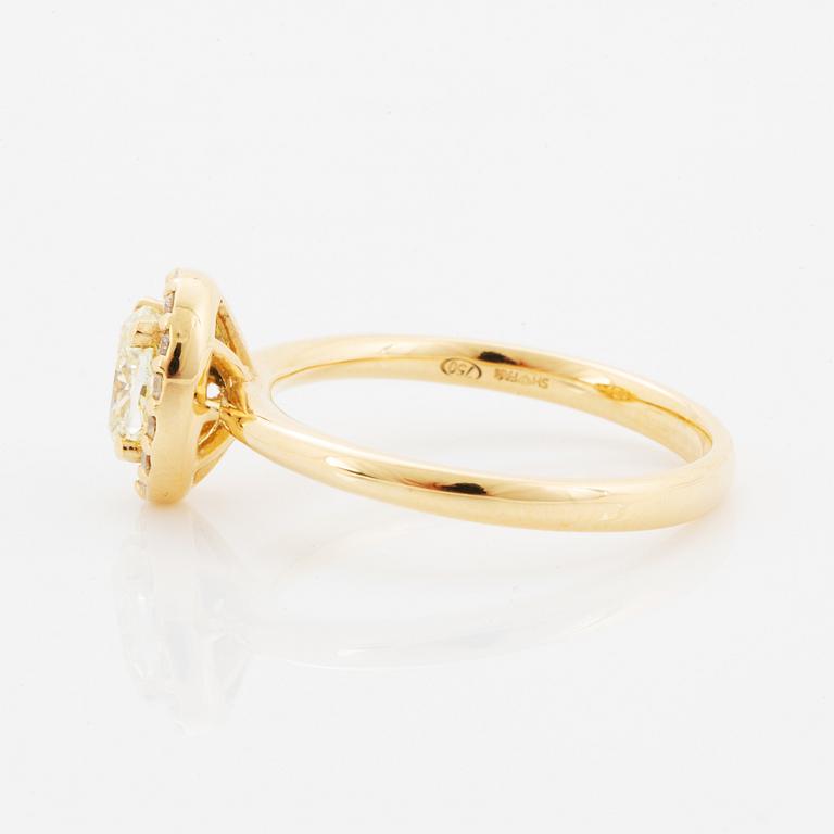 Oval light yellow diamond and brilliant-cut diamond ring.