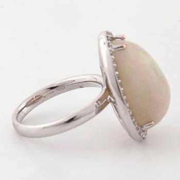 A cabochon cut white opal and a brilliant cut diamond ring.