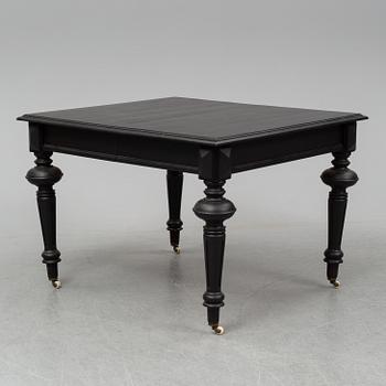 A dining table with an additional leave from around year 1900.