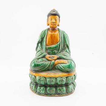 A green and yellow glazed figure of buddha, China, 20th century.