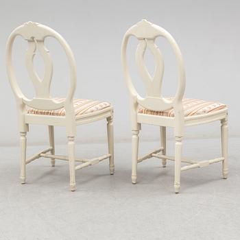 A set of eight chairs and a dining table. Gustavian style, second half of the 20th century. 2 leaves included.