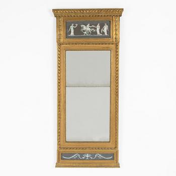 A late Gustavian giltwood and inset gouache mirror, circa 1800.