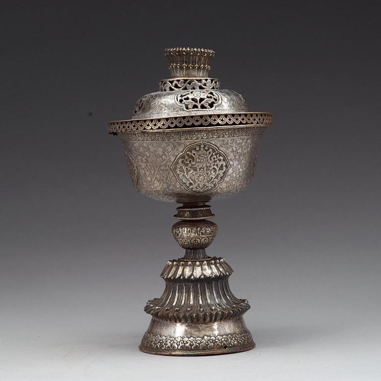 A Tibetan silver butter lamp with cover, 19th Century.