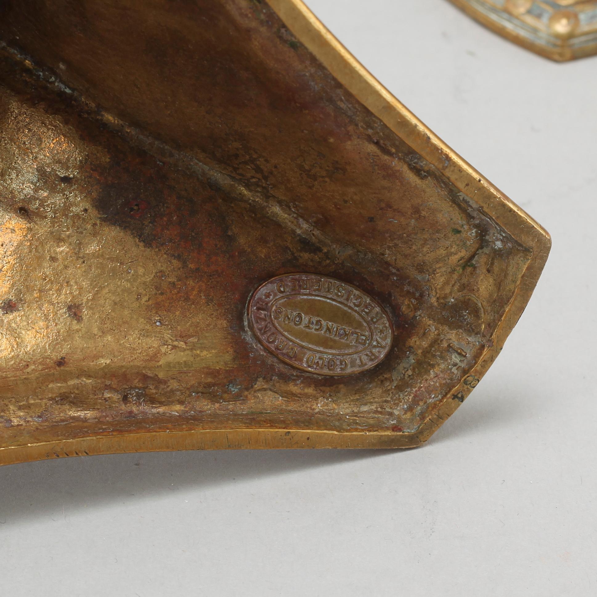 A pair of brass candlesticks from Elkingtons in Birmingham, 19th century.
