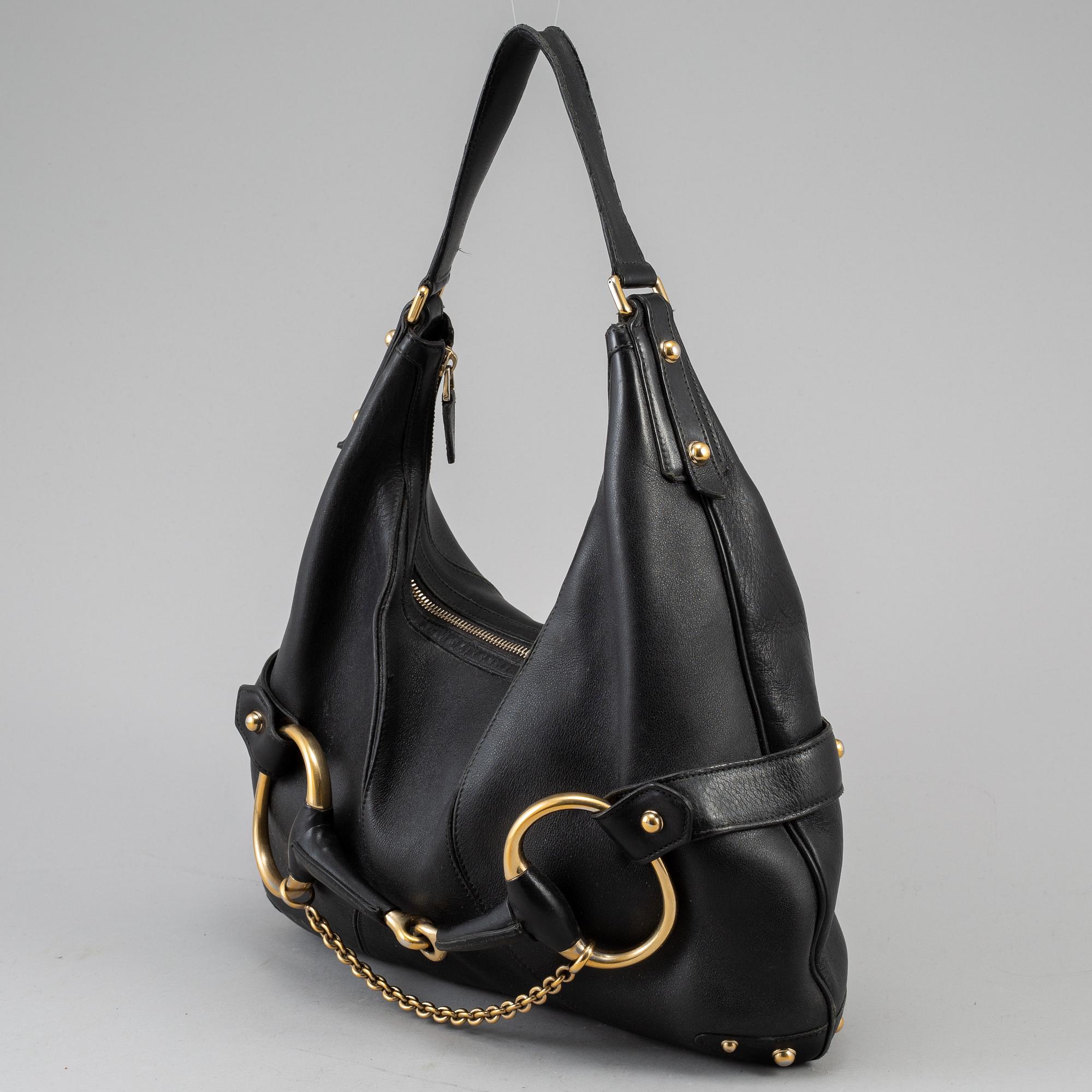 GUCCI, a leather horse-bit bag.