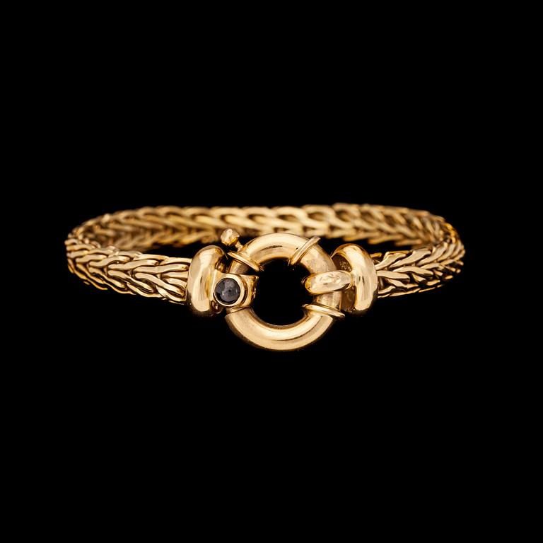 ARMBAND, guld med cabochonslipad blå safir, Italien.