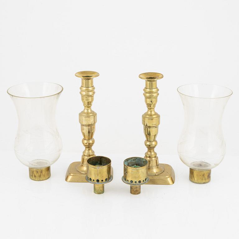 A pair of brass candlesticks with storm glass, 19th century.