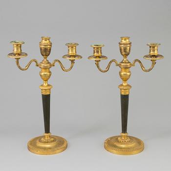A pair of French Directoire late 18th century ormolu candelabra for three candles.