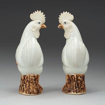 A pair of white and brown glazed figures of roosters, late Qing dynasty,