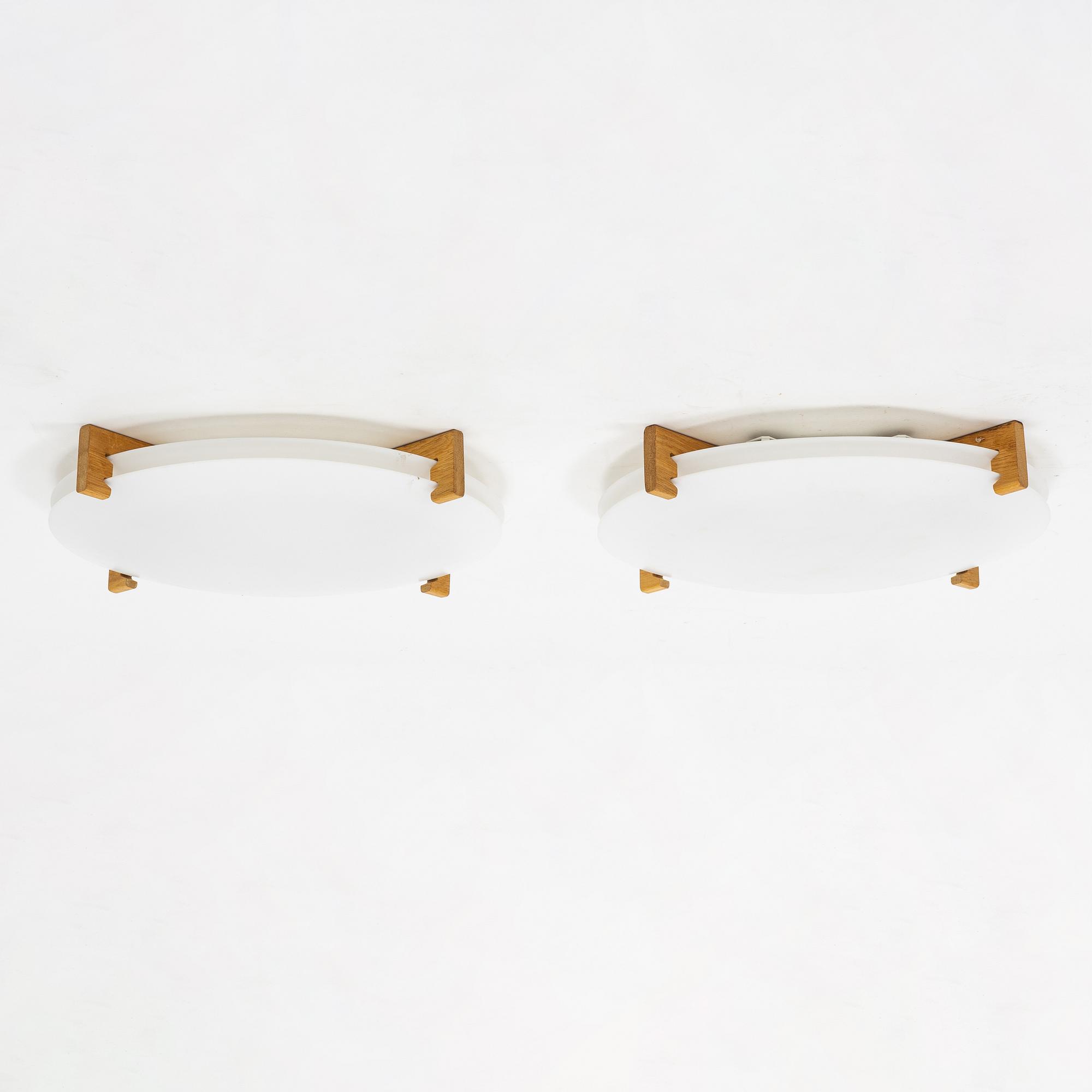 Uno & Östen Kristiansson, a pair of 'Plafo' plastic and oak ceiling lights, Luxus, Vittsjö.