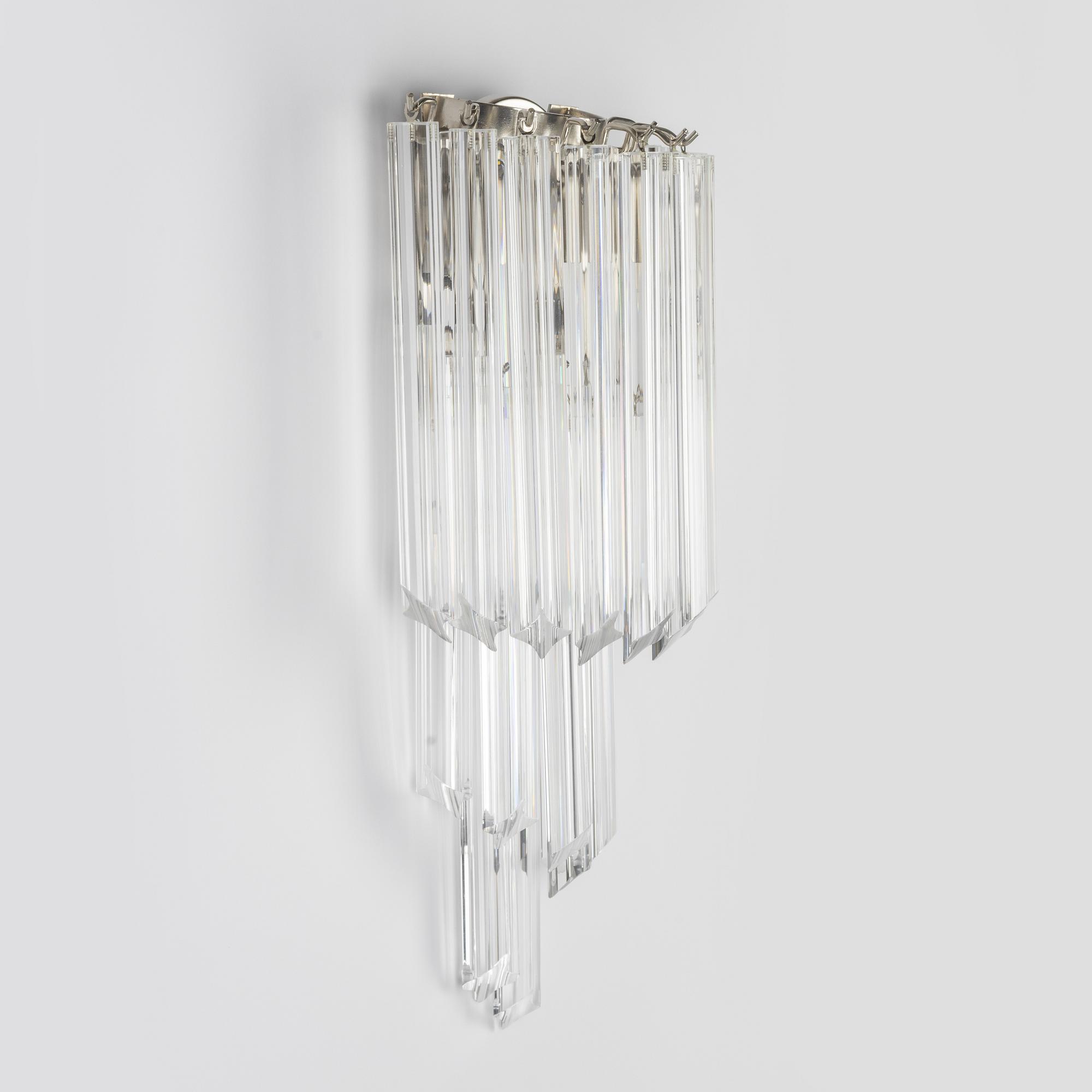 A pair of glass and metal wall lights.