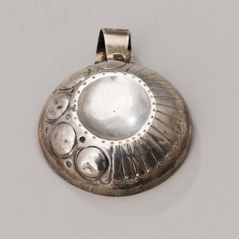 A French silver tastevin marked J.G, 1819-1838.