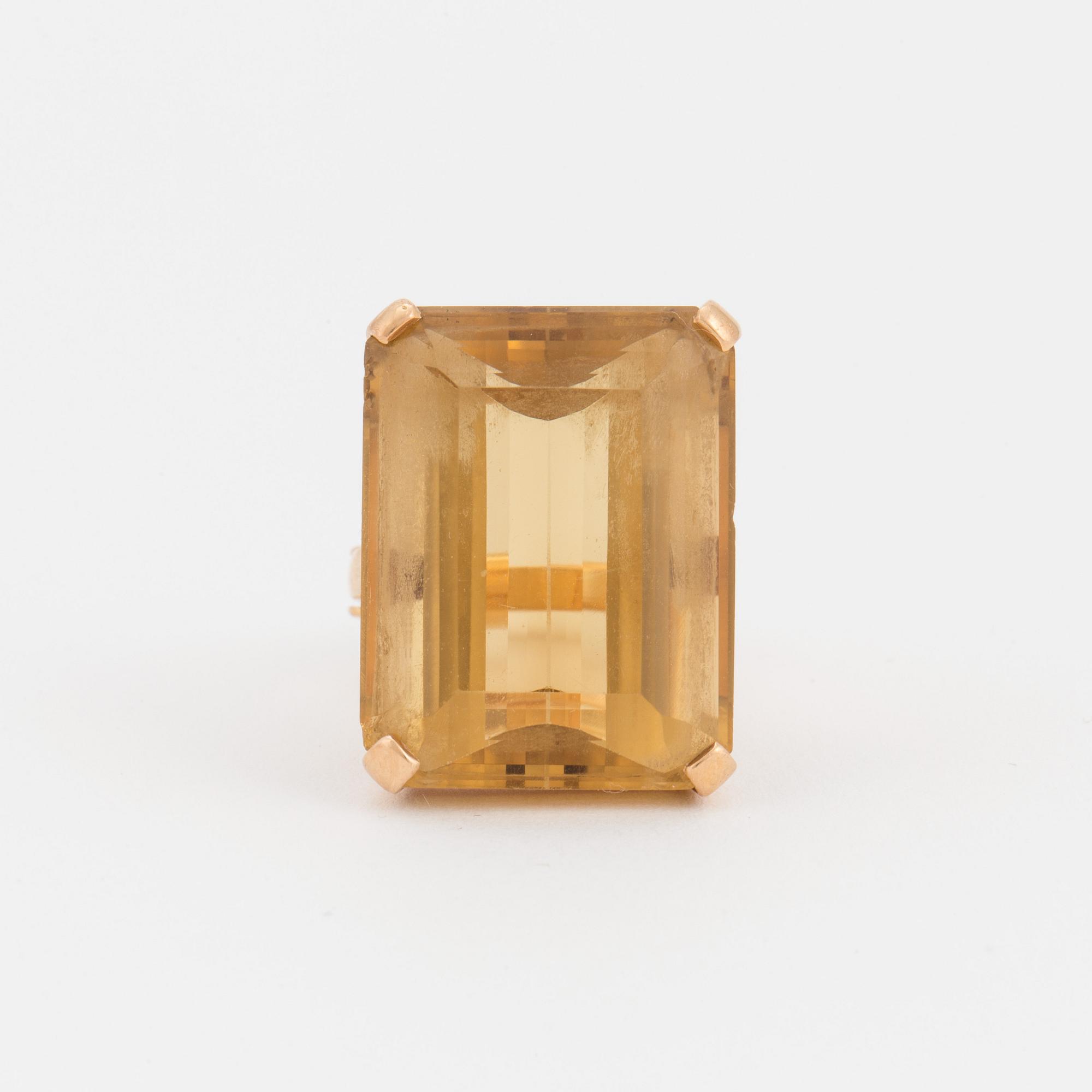 A ring set with a step-cut citrine.