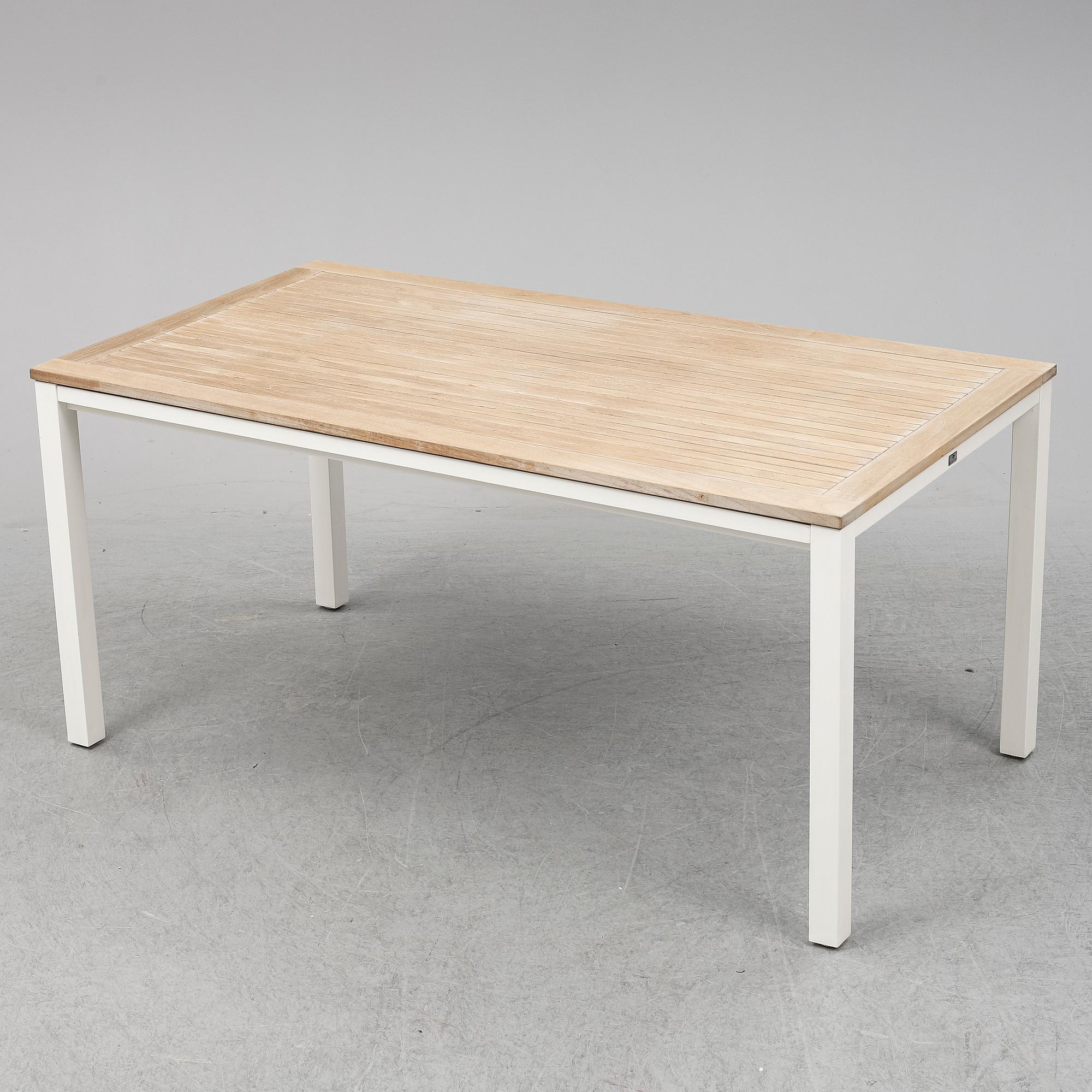 A garden table with four chairs, Gloster.
