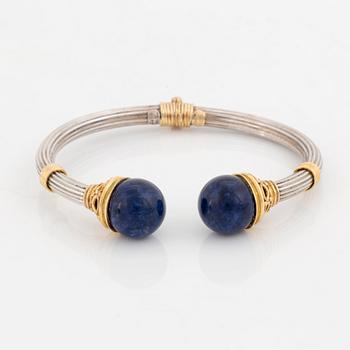 An Ilias Lalaounis demi parure comprising a necklace, a bracelet and a ring in silver and 18K gold set with sodalite.