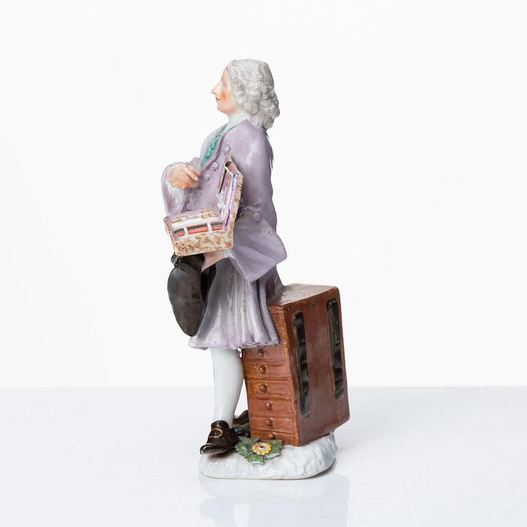 A Meissen porcelain figure of a trinket salesman from the series of Parisian street-traders, circa 1745.