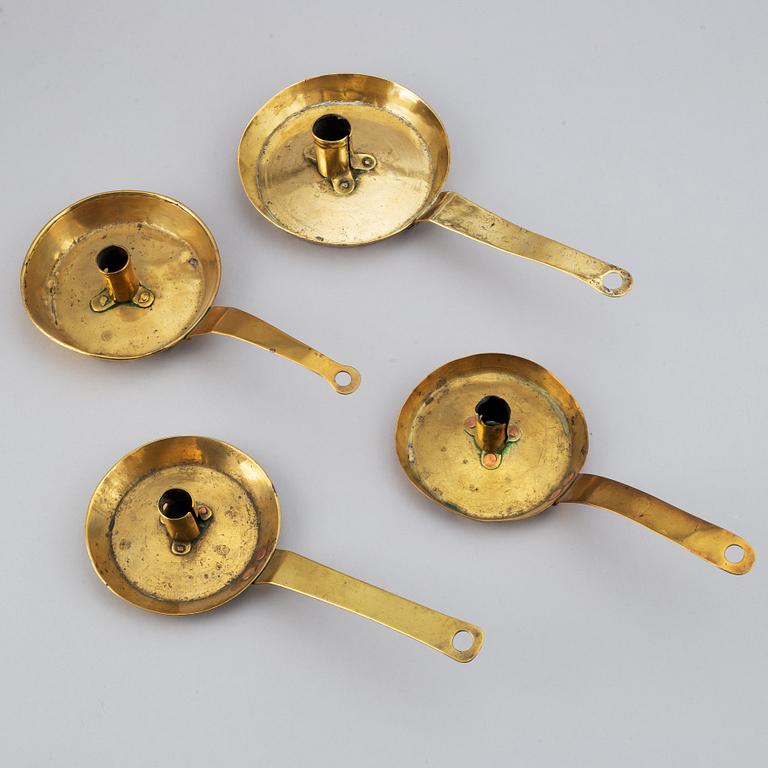 Four 18th century brass night light holders.