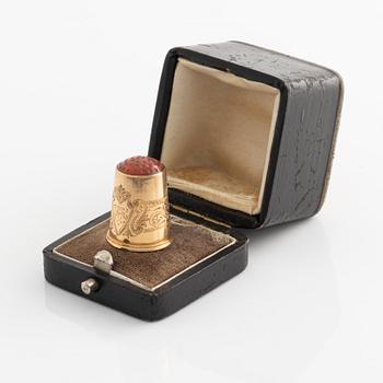 An 18K Gold Thimble with carnelian.