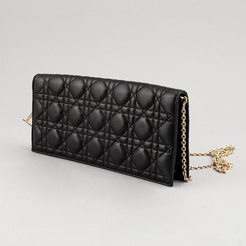 Christian Dior, a quilted leather handbag/clutch.