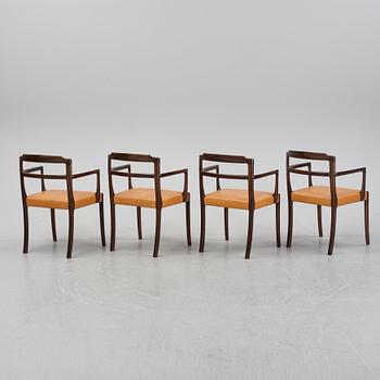 A set of four black stained beech tree arm chairs with leather upholstery, second half of the 20th century.