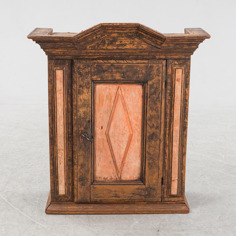 A late Baroque painted wall cabinet, dated 1757.