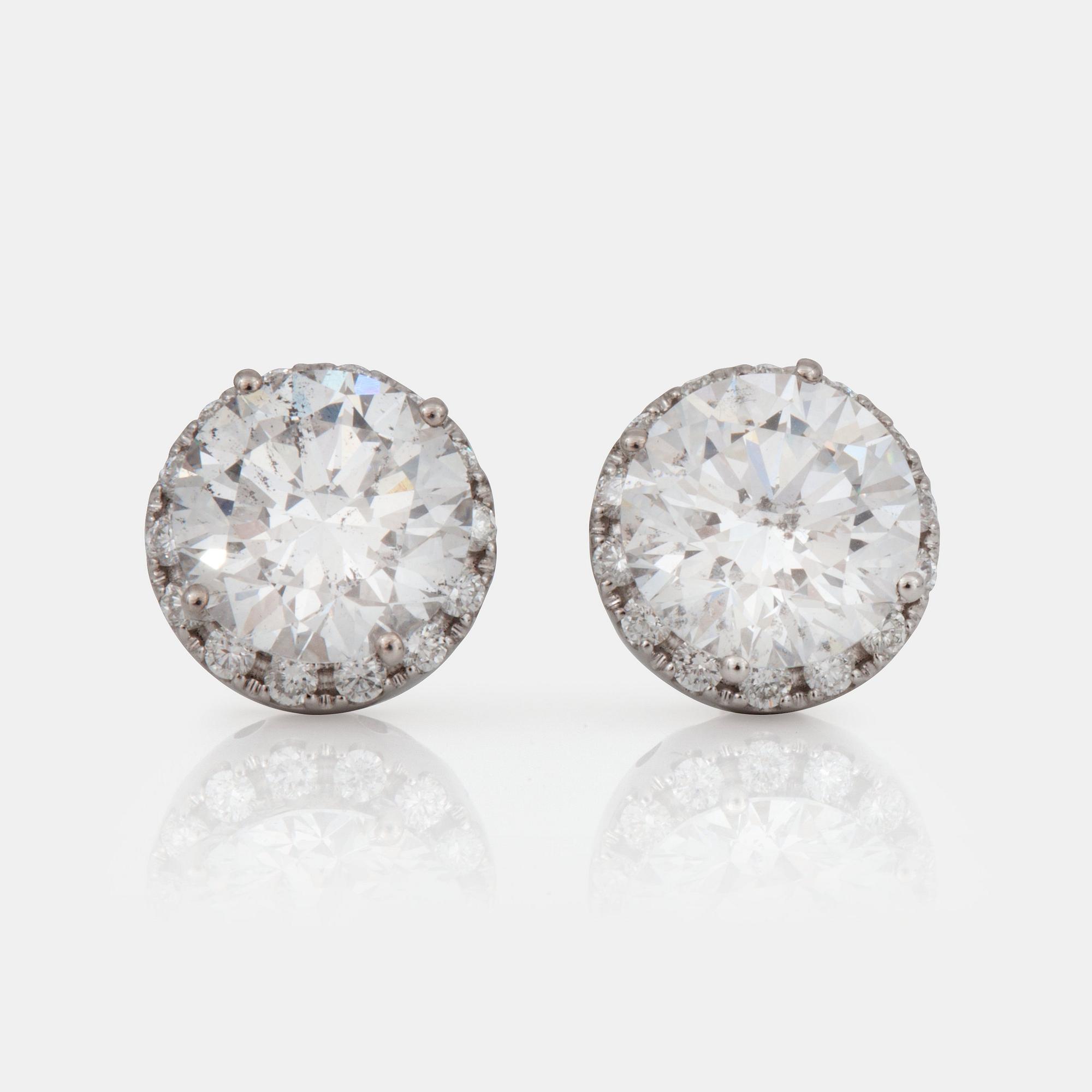A pair of brilliant-cut diamond earrings. 2.07 cts and 2.11 cts, D-E/SI2, according to certificates from HRD and IGI.