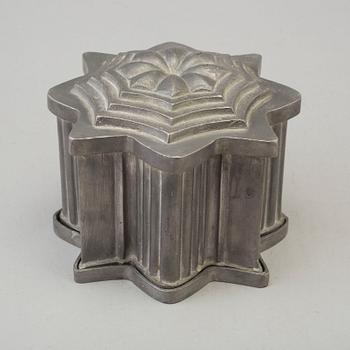 a pewter ice cream mold from the 19th century.