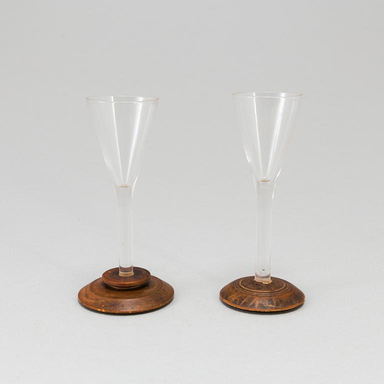 Two folk art glasses with wooden feet 19th century.