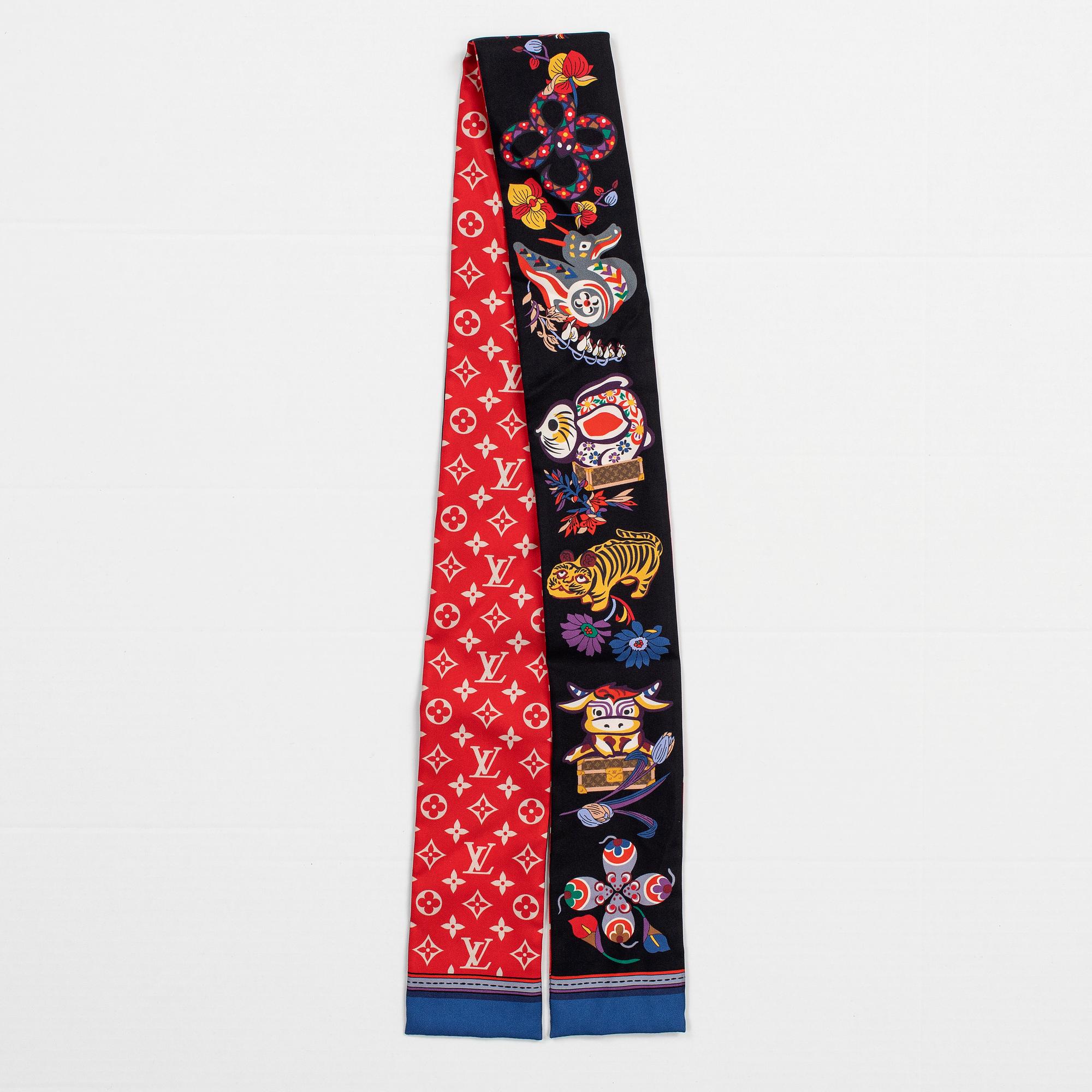 A Louis Vuitton silk monogram 'Superstition' bandeau scarf.