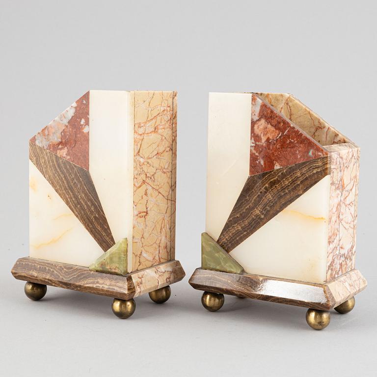 An Art Déco marble mantle clock and a pair of book ends, 1920's.