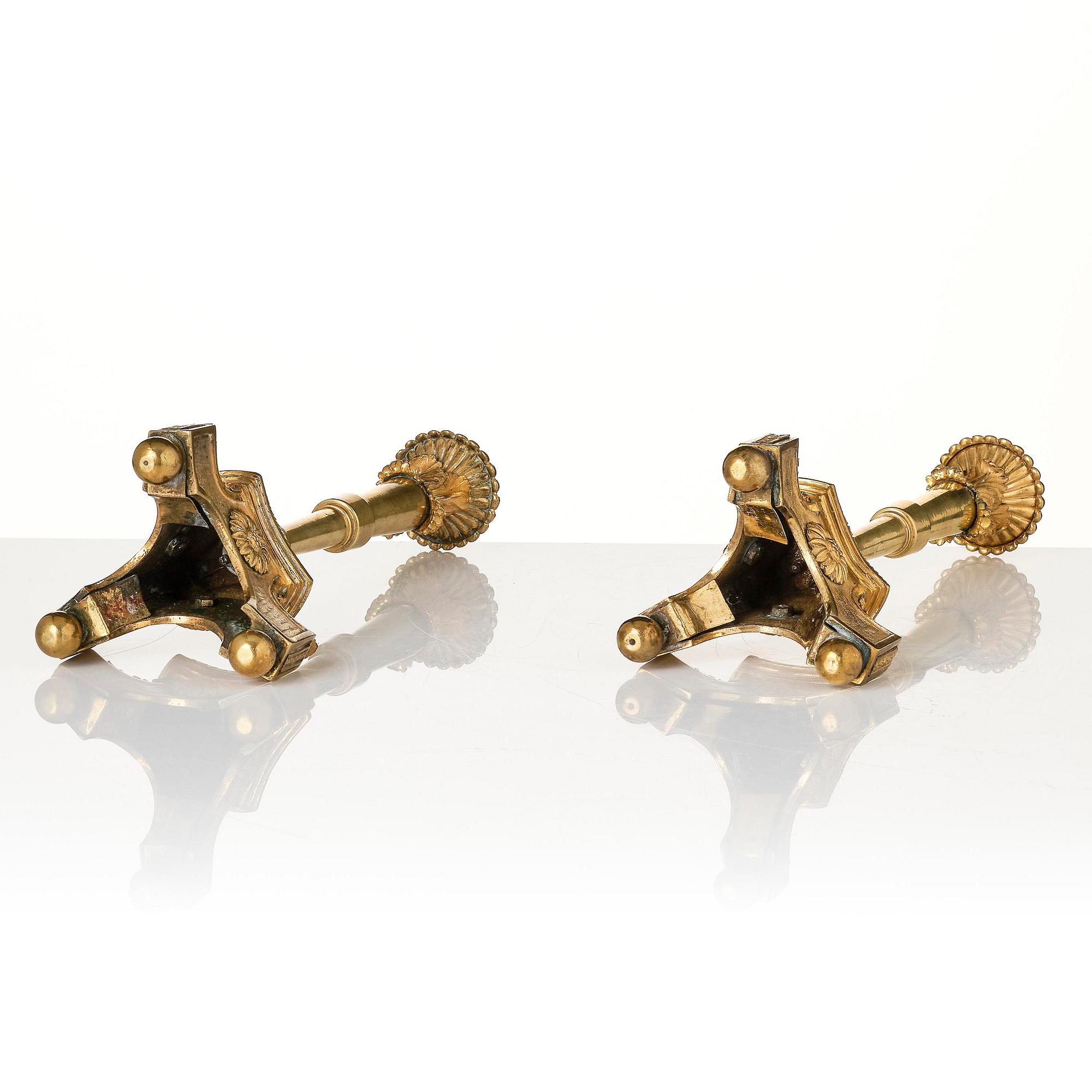 A pair of presumably Italian Empire ormolu candlesticks, early 19th century.