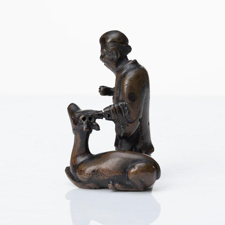 A bronze scultpure of the God of Longevity Sholaou and his deer, Qing dynasty, 18th Century.