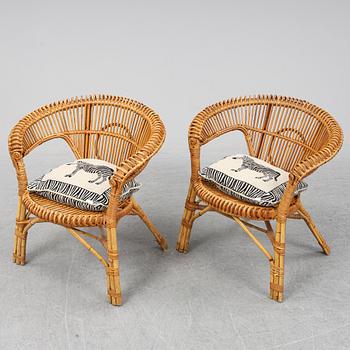 A pair of rattan chairs.