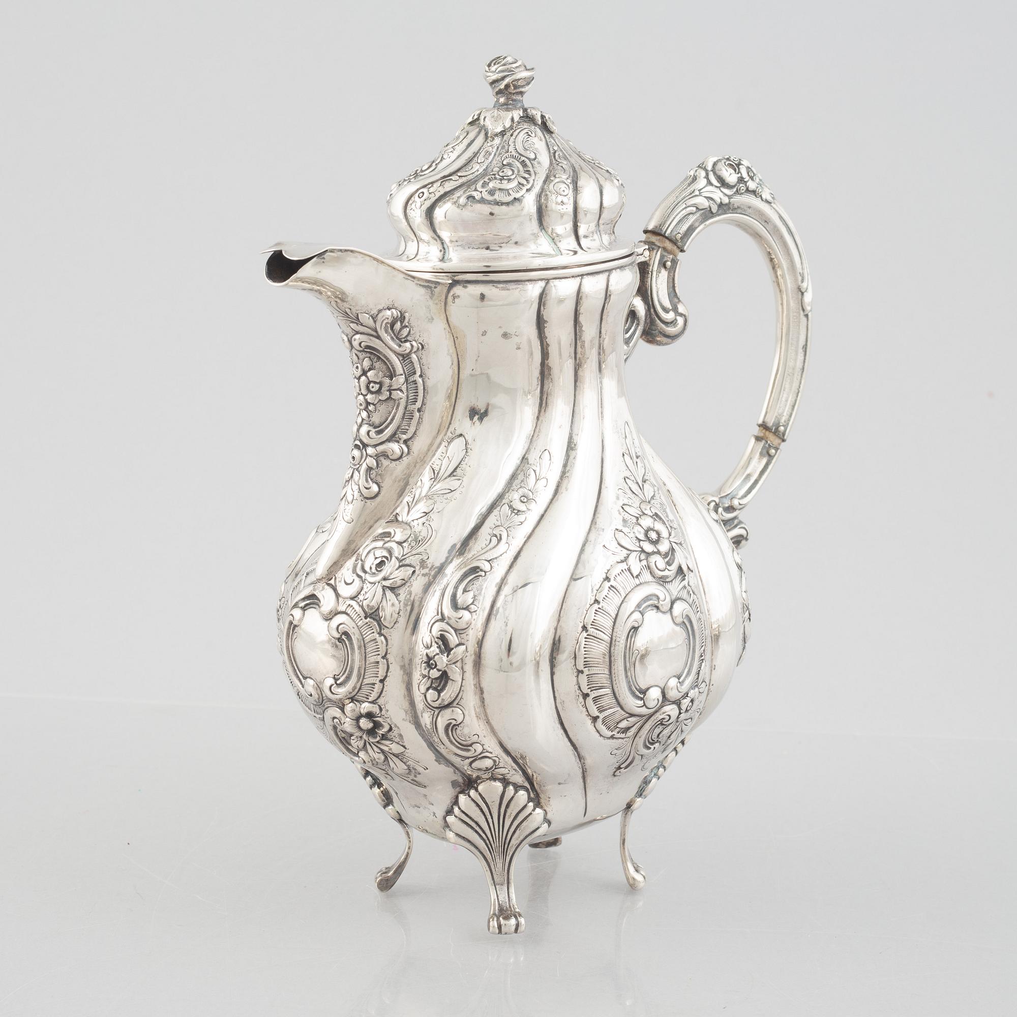 A Rococo-style silver coffee pot, creamer and sugar bowl, 20th Century.