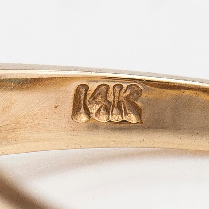 Ring, ca 10-11K gold with a pear shaped emerald and diamonds approx 0.10 ct in total.