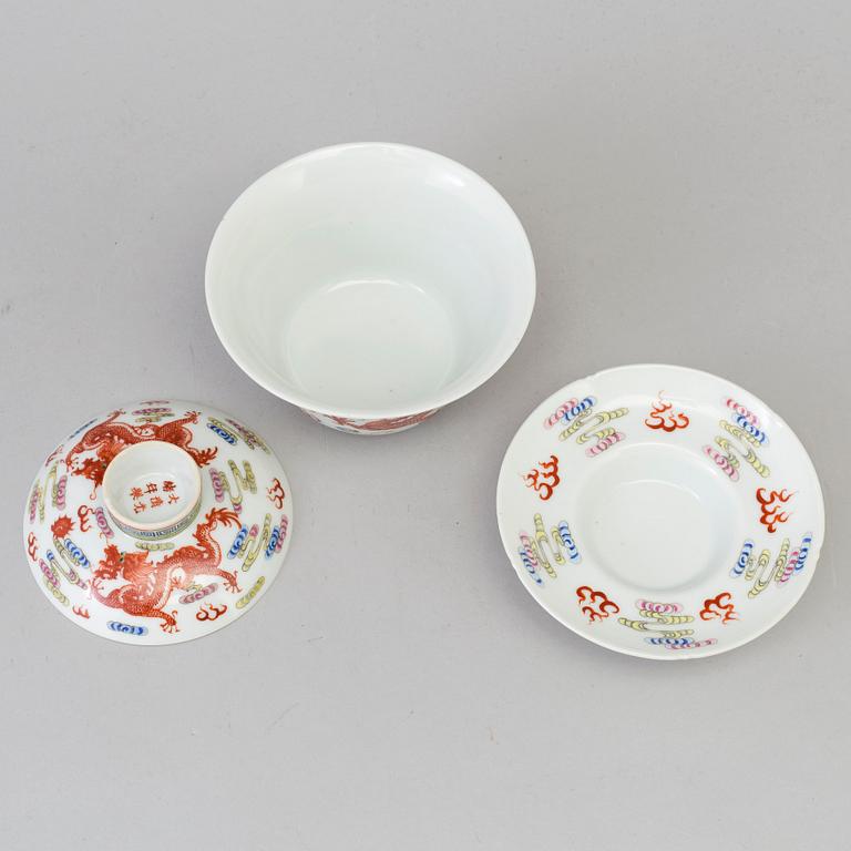 A Chinese 20th century famille rose porcelain cup with cover and dish, with Guangxus six character mark.