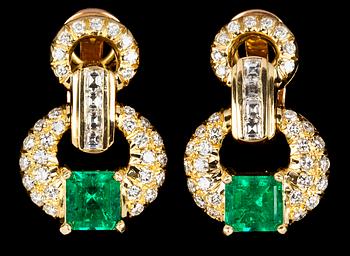 1067. A pair of emerald and diamond earrings.