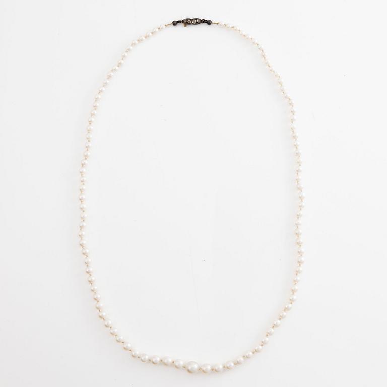 A necklace of cultured pearls clasp with old-cut diamonds.