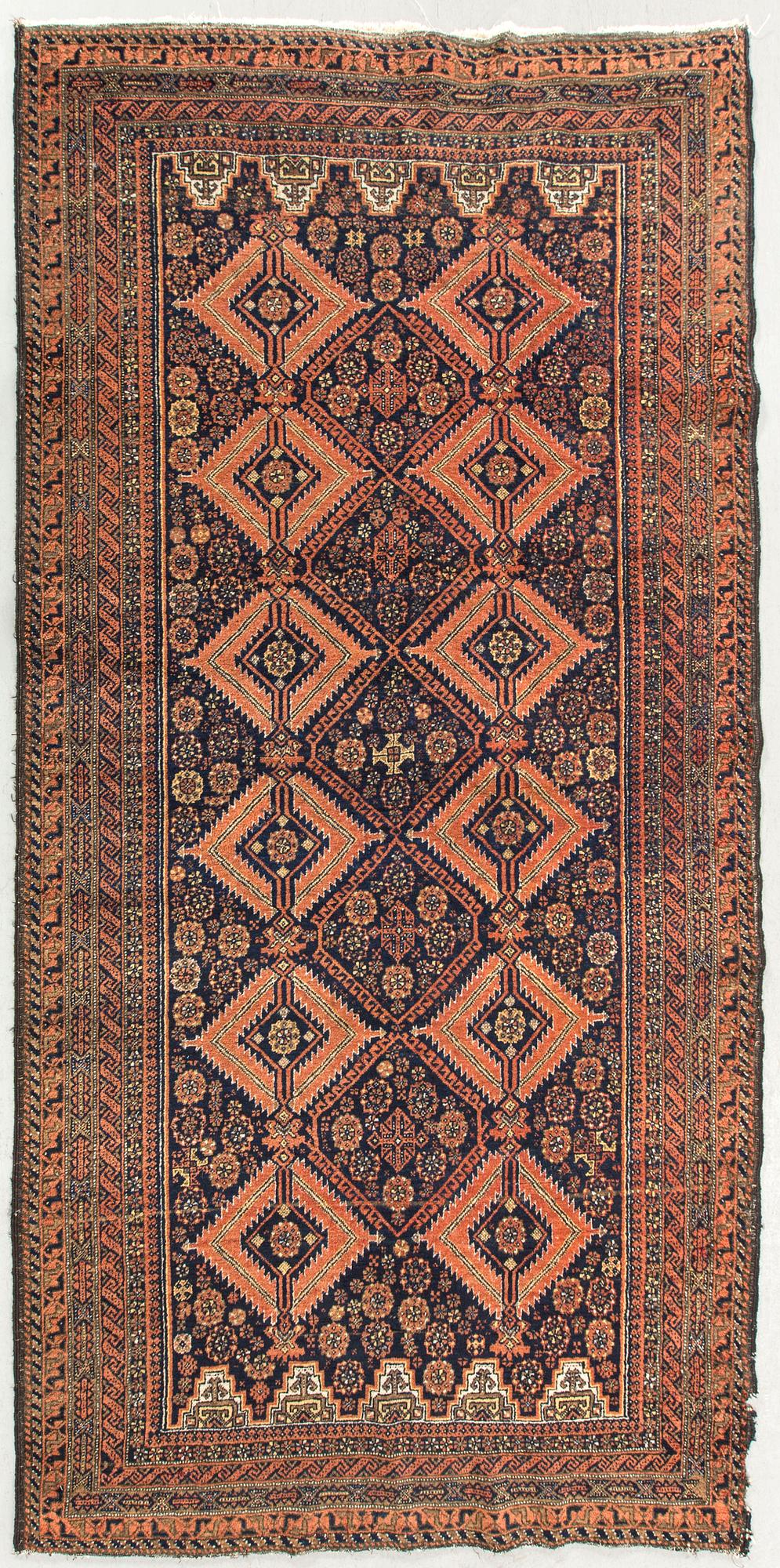 An antique Beludj carpet ca 227 x 122 cm.